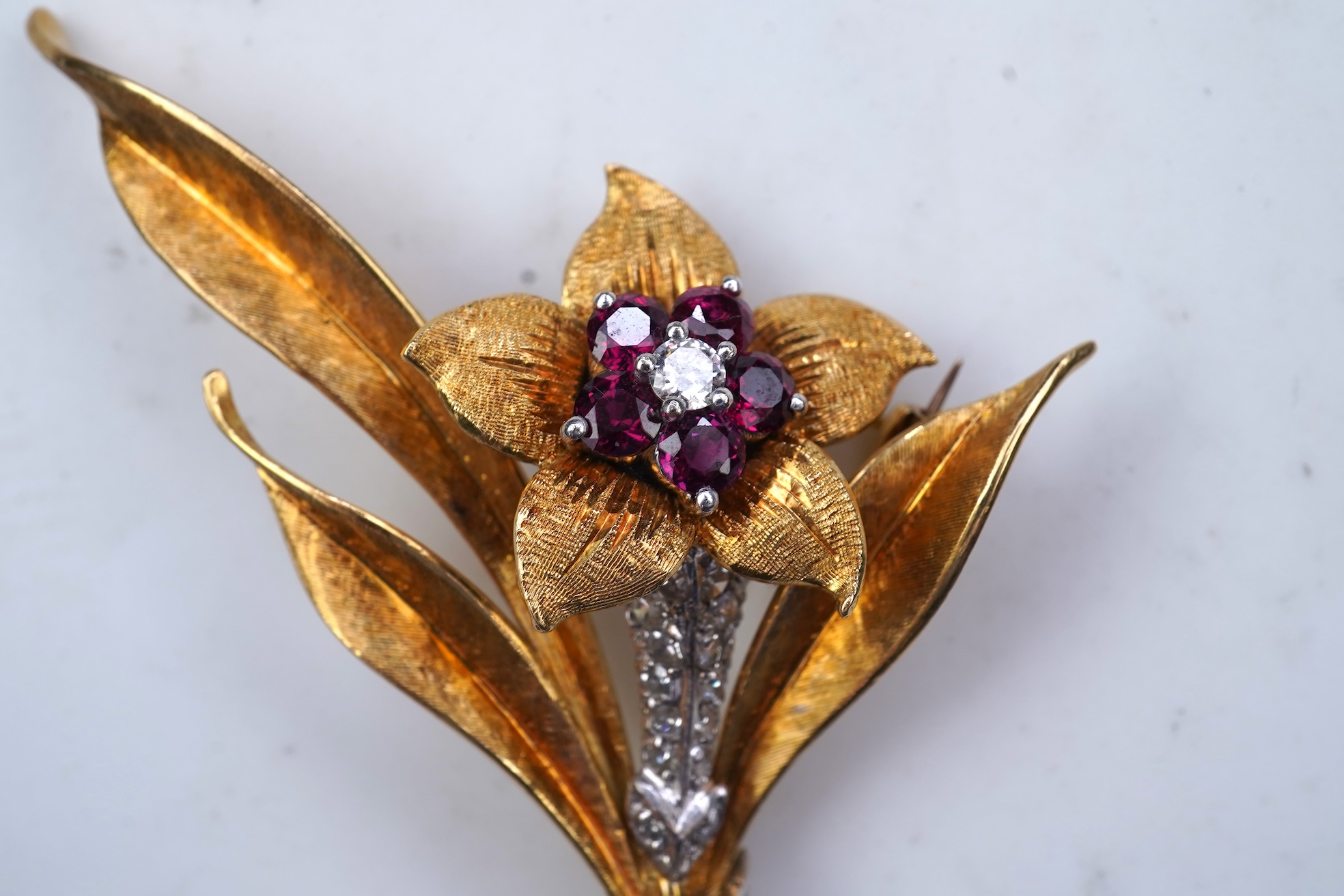 A gold, ruby and diamond brooch, circa 1966